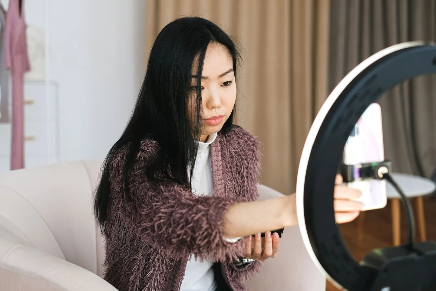 Creator recording a video with her phone and ring light