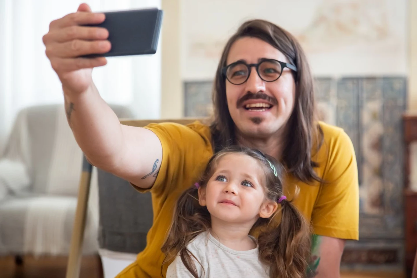 A father and daughter enjoying a selfie together