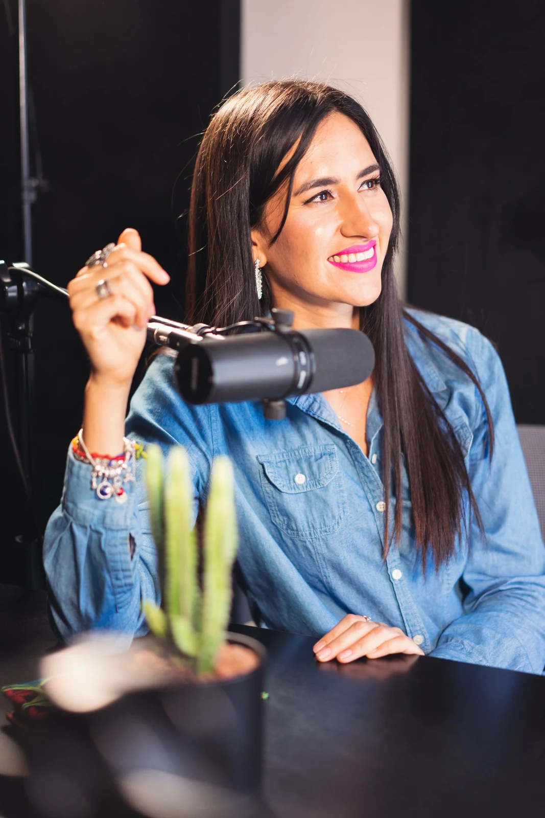 A podcaster speaking into a studio microphone